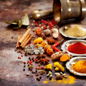 Indian Spices and herbs in silver bowls and old mortar. Food and cuisine ingredients.